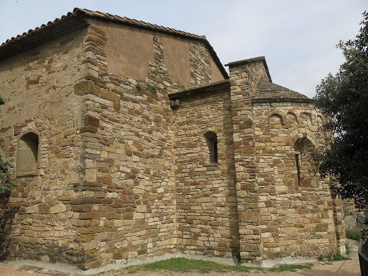 Stone apses and tiled roofs of Sant Cristòfol church in Tavertet