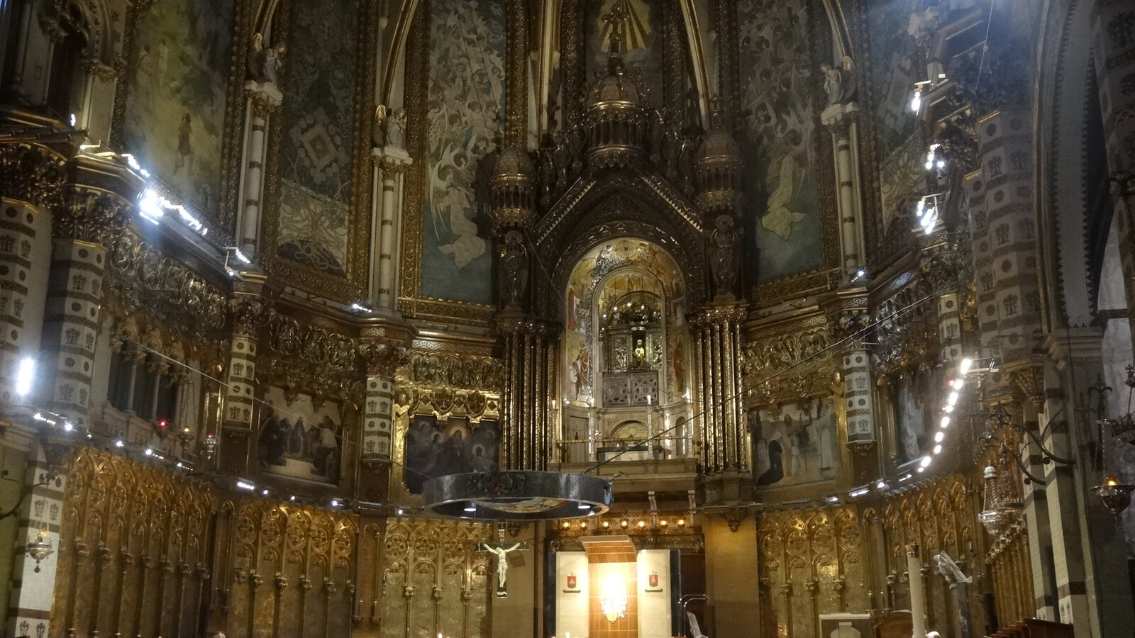 Monks and congregation gathered for vespers before the ornate altar inside Montserrat basilica