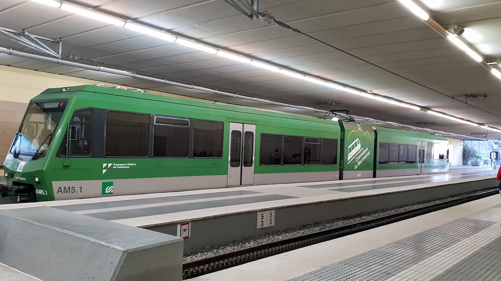Green rack railway train waiting at the covered Montserrat-Monestir platform
